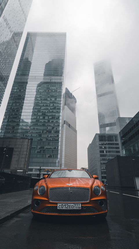 Download wallpaper 2160x3840 bentley continental gt, bentley, car, orange, front view, city, buildings samsung galaxy s4, s5, note, sony xperia z, z1, z2, z3, htc one, lenovo vibe hd background