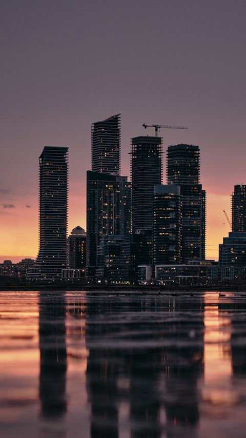 Download wallpaper 2160x3840 buildings, city, water, reflection, sunset, dusk samsung galaxy s4, s5, note, sony xperia z, z1, z2, z3, htc one, lenovo vibe hd background
