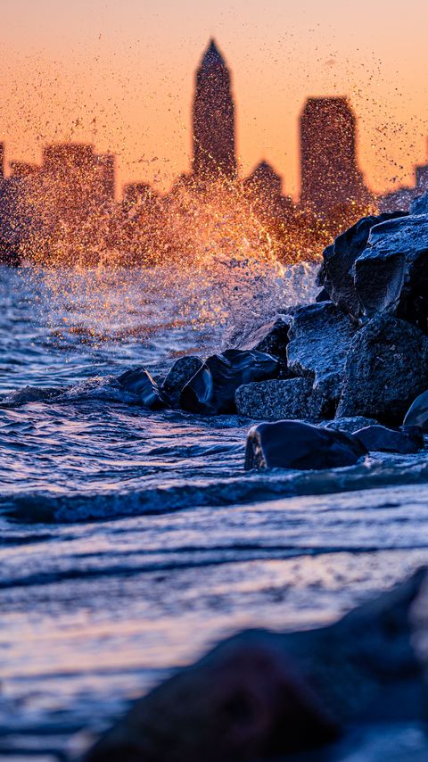 Download wallpaper 2160x3840 water, waves, spray, stones, city, sunset samsung galaxy s4, s5, note, sony xperia z, z1, z2, z3, htc one, lenovo vibe hd background