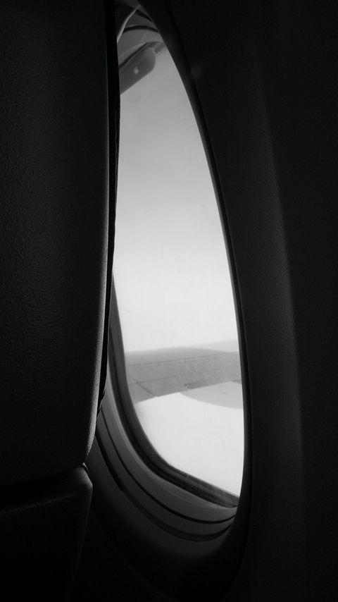 Download wallpaper 2160x3840 window, porthole, wing, view, darkness, black and white samsung galaxy s4, s5, note, sony xperia z, z1, z2, z3, htc one, lenovo vibe hd background