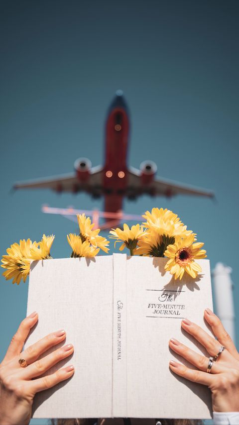 Download wallpaper 2160x3840 book, flowers, hands, reading, plane samsung galaxy s4, s5, note, sony xperia z, z1, z2, z3, htc one, lenovo vibe hd background