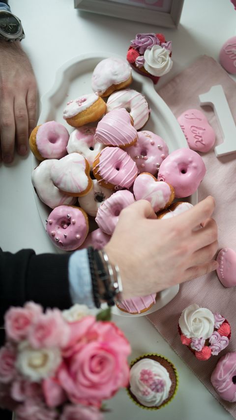 Download wallpaper 2160x3840 donuts, glaze, dessert, pink, hand samsung galaxy s4, s5, note, sony xperia z, z1, z2, z3, htc one, lenovo vibe hd background