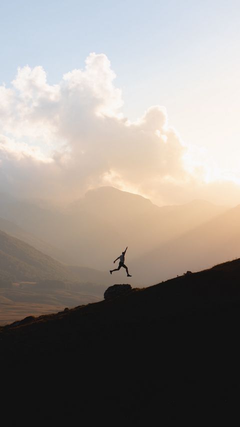 Download wallpaper 2160x3840 silhouette, jump, mountains, light, dark samsung galaxy s4, s5, note, sony xperia z, z1, z2, z3, htc one, lenovo vibe hd background