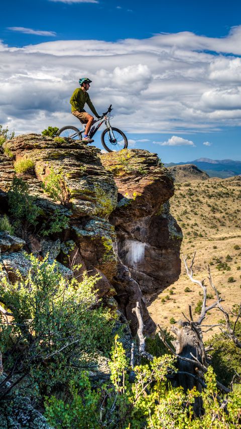 Download wallpaper 2160x3840 cyclist, bike, rock, cliff, nature samsung galaxy s4, s5, note, sony xperia z, z1, z2, z3, htc one, lenovo vibe hd background