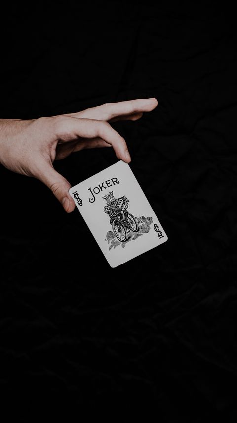 Download wallpaper 2160x3840 joker, playing card, card, word, hand samsung galaxy s4, s5, note, sony xperia z, z1, z2, z3, htc one, lenovo vibe hd background