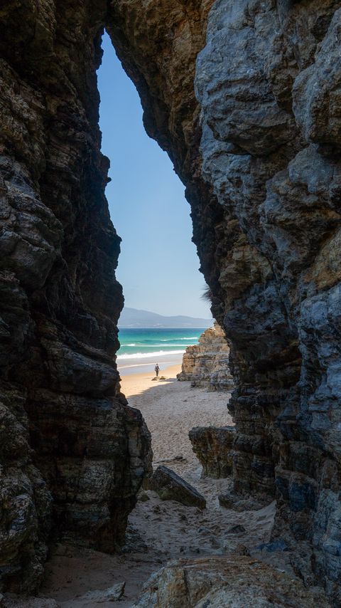 Download wallpaper 2160x3840 rock, arch, beach, man, sea, nature samsung galaxy s4, s5, note, sony xperia z, z1, z2, z3, htc one, lenovo vibe hd background
