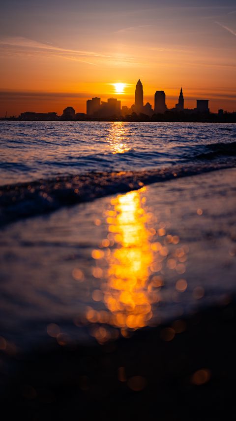 Download wallpaper 2160x3840 sea, waves, coast, city, sunset samsung galaxy s4, s5, note, sony xperia z, z1, z2, z3, htc one, lenovo vibe hd background